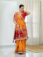 Tulsi Vat Savitri Special: Orange Yellow Vichitra Silk Saree with Narrative Embroidery & Latkan Tassels
