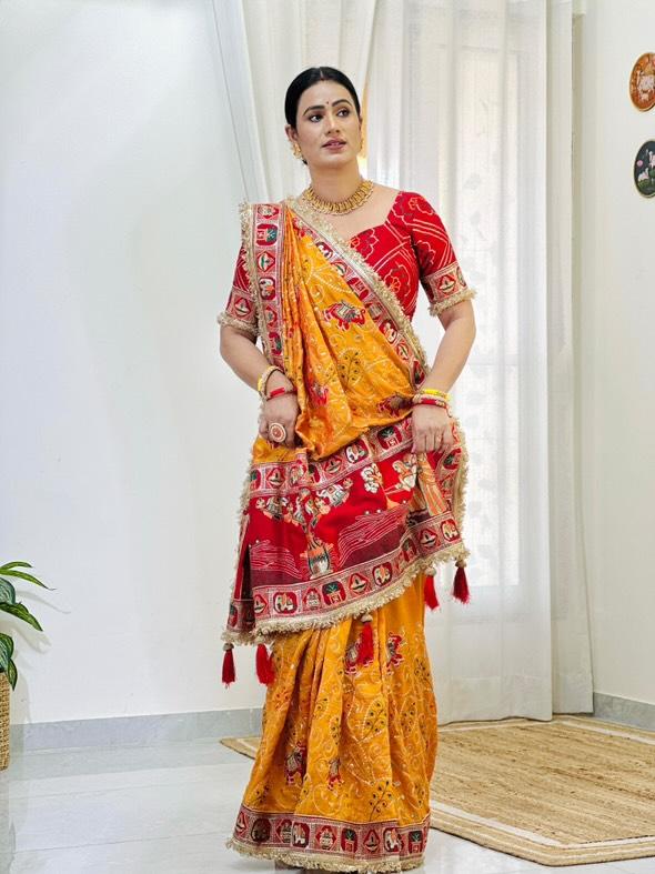 Tulsi Vat Savitri Special: Orange Yellow Vichitra Silk Saree with Narrative Embroidery & Latkan Tassels
