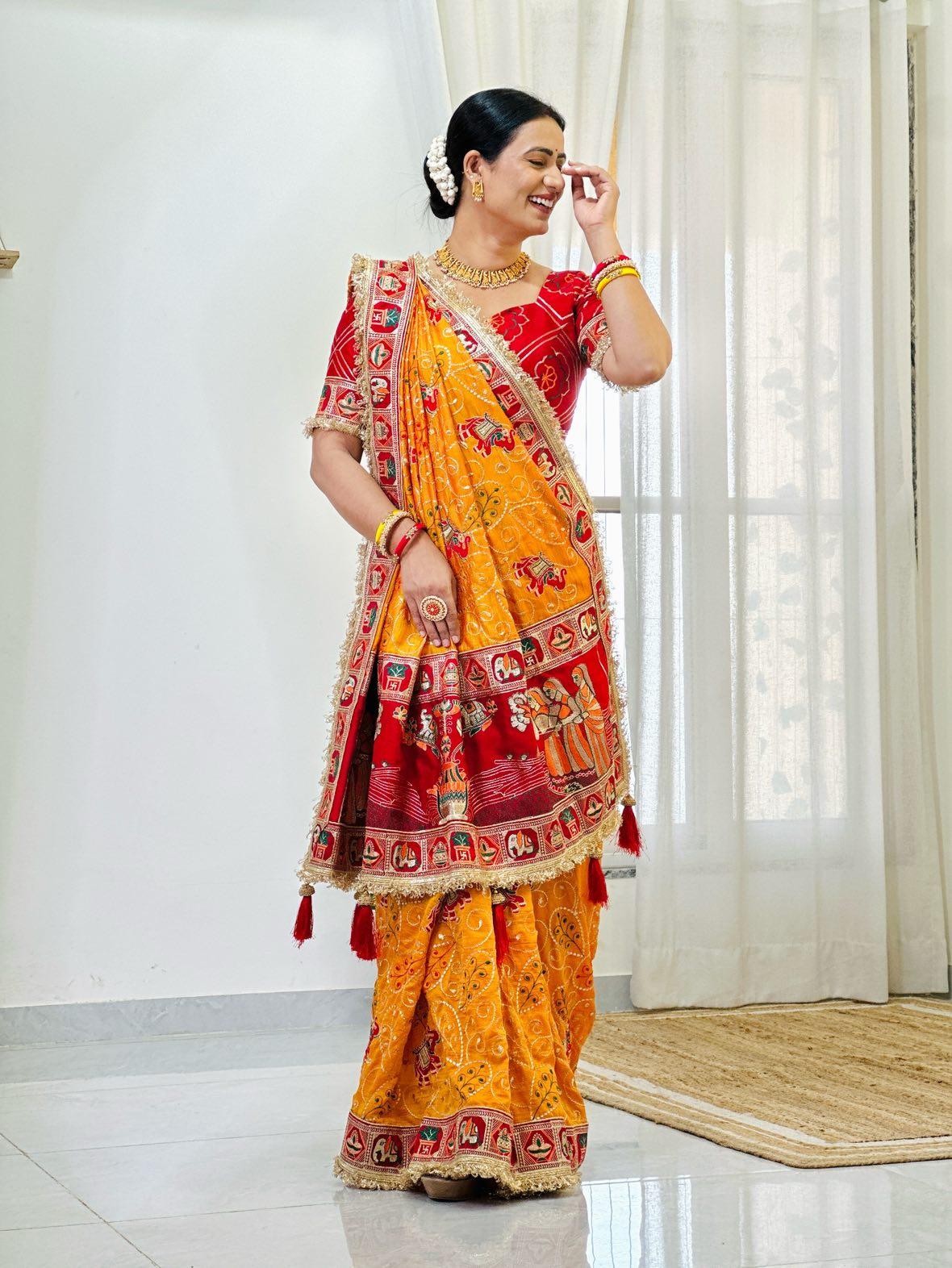 Tulsi Vat Savitri Special: Orange Yellow Vichitra Silk Saree with Narrative Embroidery & Latkan Tassels